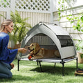 Grey elevated dog cot bed with removable canopy, cooling pad, and mesh sides