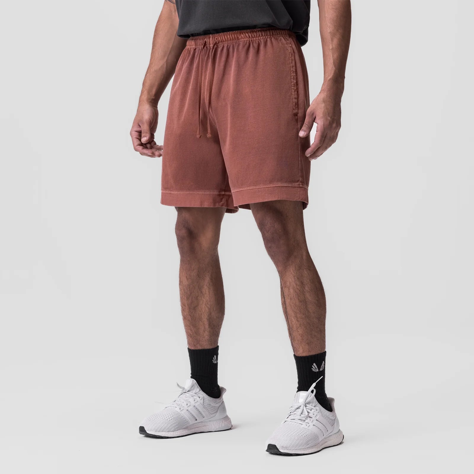 Rust-orange quick-dry gym shorts with elastic waistband and drawstring; side zip pocket