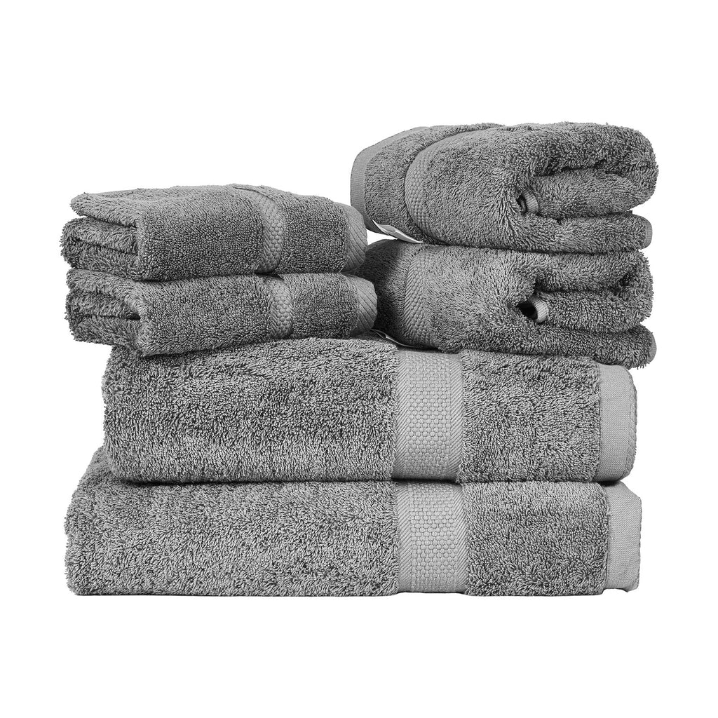 Four folded grey towels with stitched cuffs and plush looped terry pile