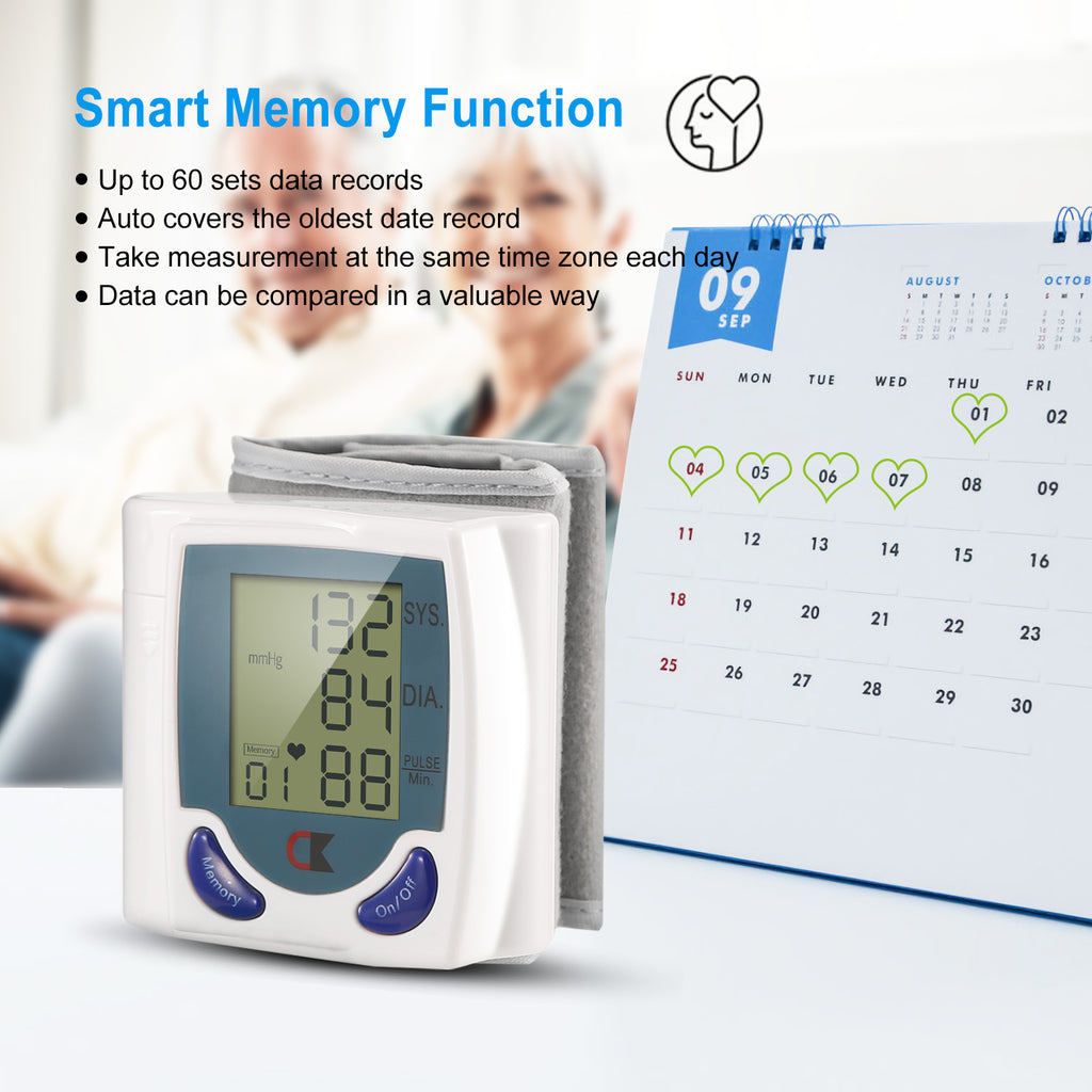 White wrist cuff blood pressure monitor with gray cuff and blue LCD display.