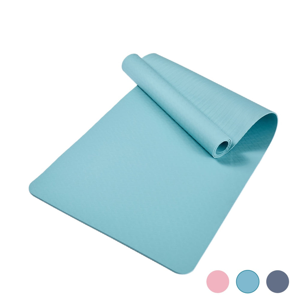 Folded turquoise yoga mat laid flat on a white background
