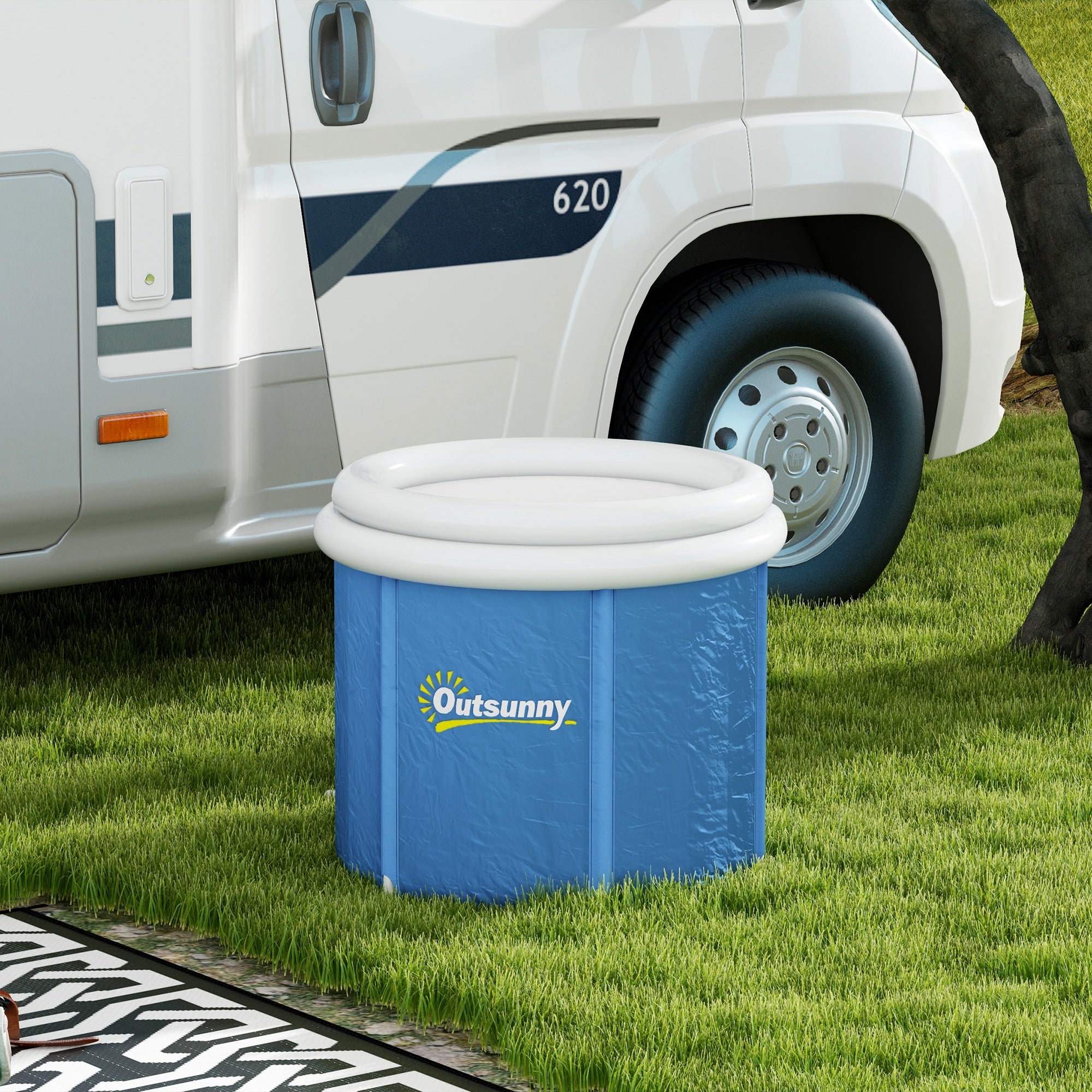 Blue portable ice bath tub set up outdoors on grass near a van
