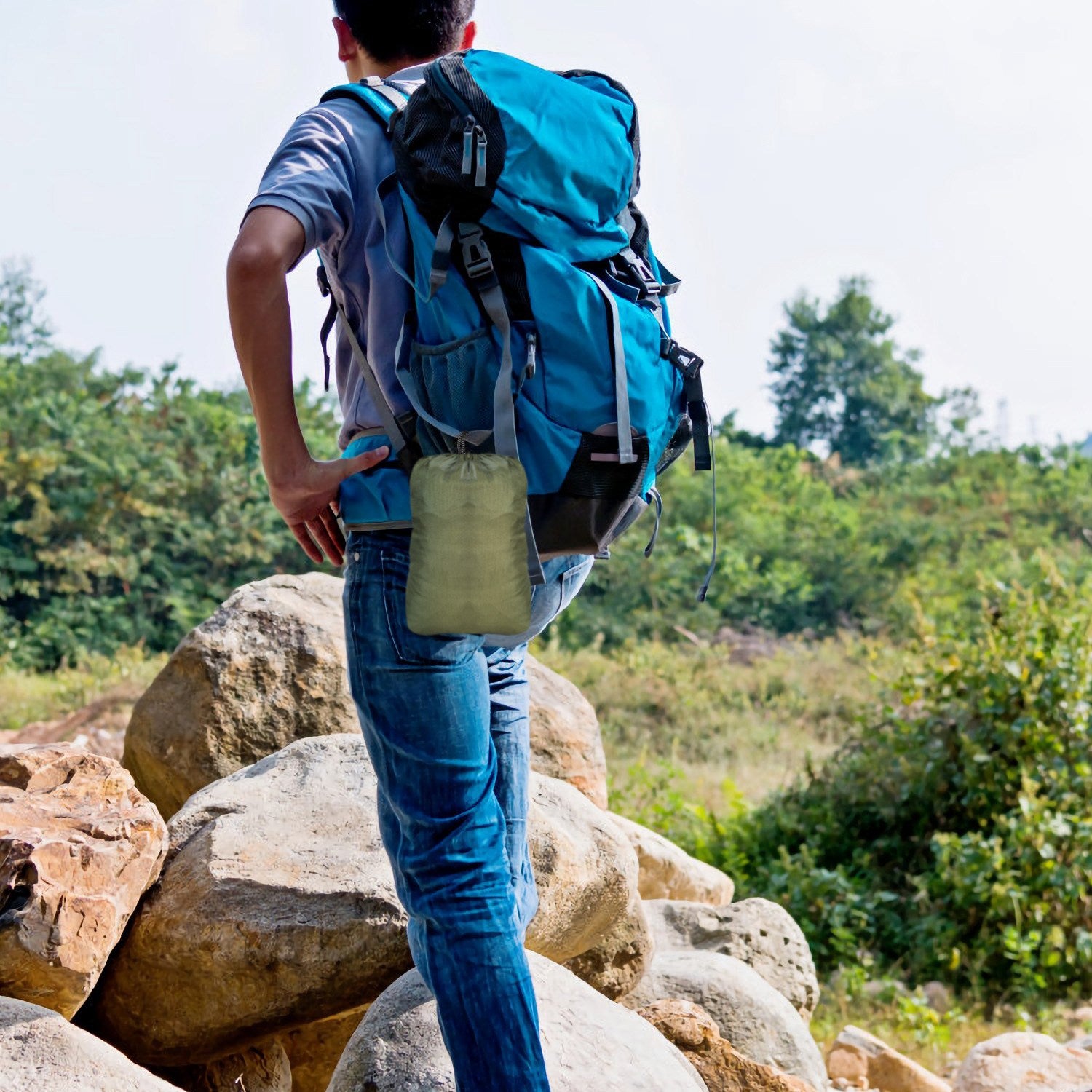 Camouflage hammock storage bag accessory on a travel backpack.