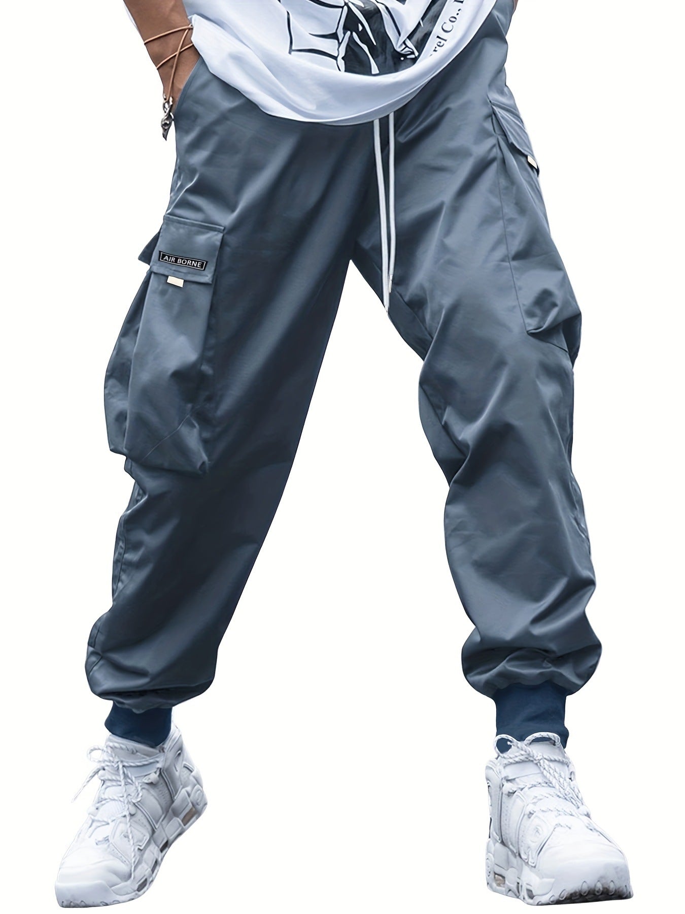 Navy blue cargo pants with drawstring hem and multi-pocket utility side panels