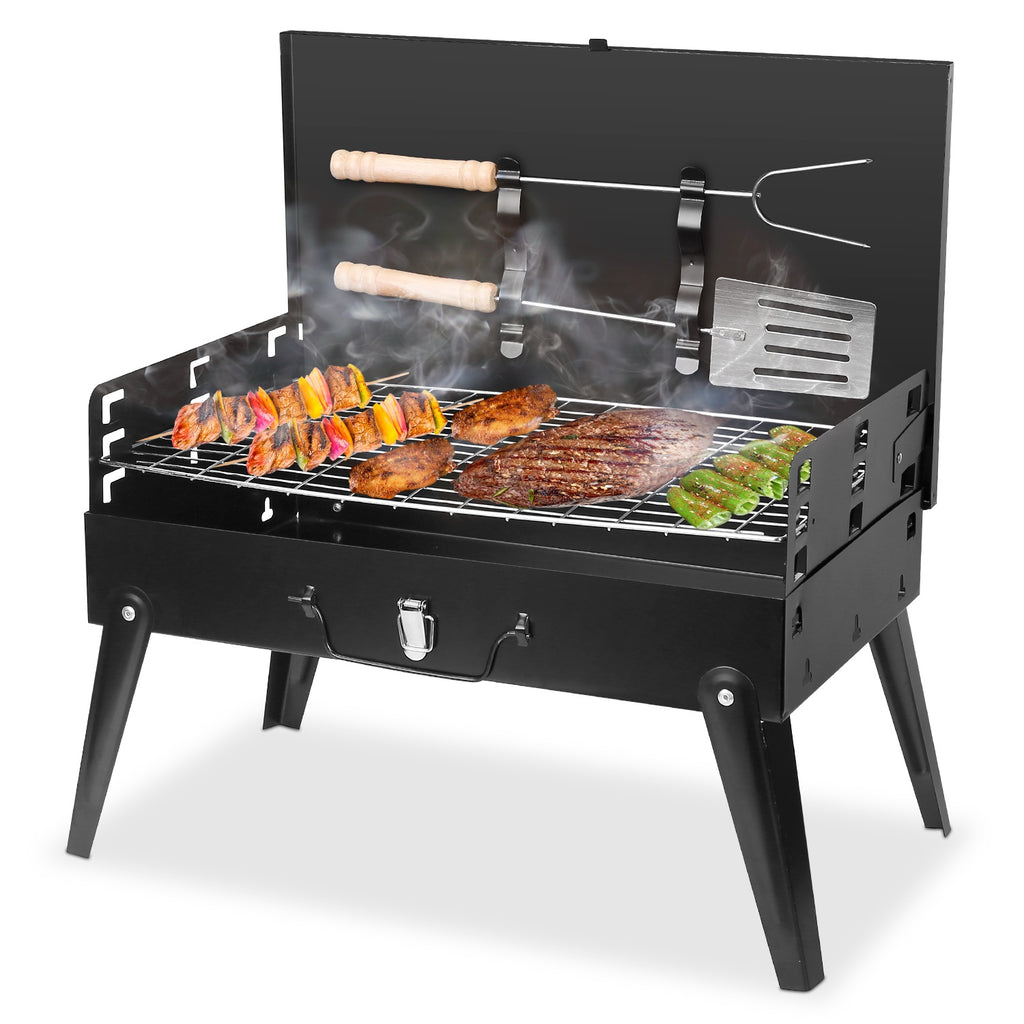 Black portable charcoal BBQ grill with lid open, cooking grates and side tools