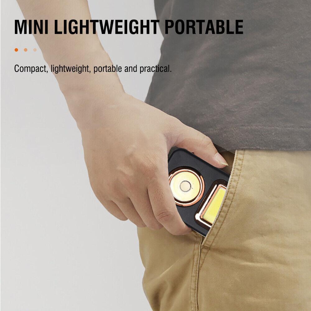 Compact portable lantern tucked near a tent fabric opening with glowing front panel light