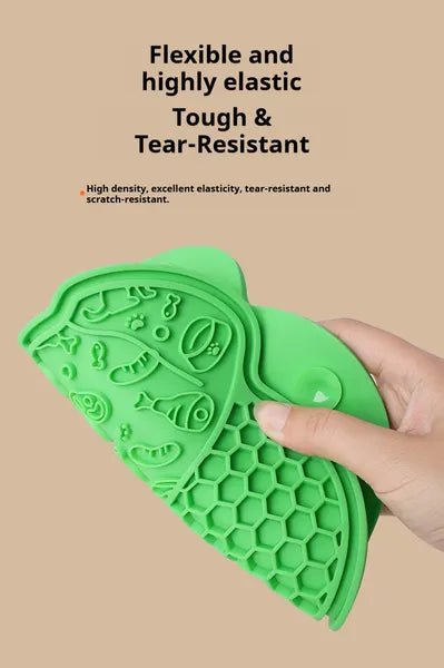 Green silicone pet licking mat close-up with raised ridges and paw-print style pattern