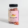 Multivitamin gummies bottle with black cap and a few red bear gummies in front