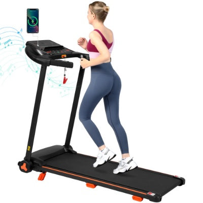 Black treadmill with orange accents and console screen, woman walking on belt