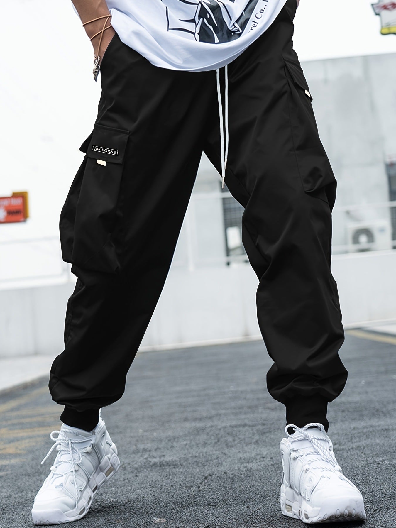 Black cargo jogger pants with drawstring tie and side flap utility pockets