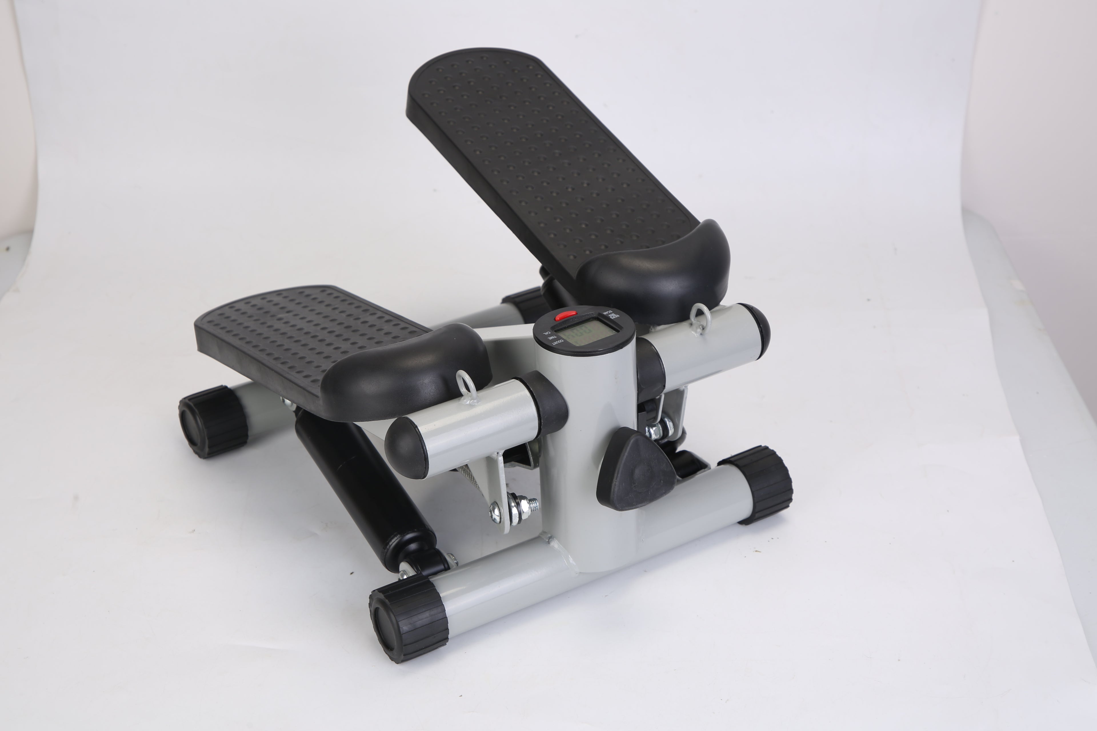 Mini fitness stepper with black textured step pads, silver base, and LCD center console