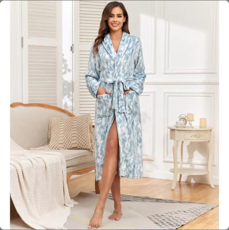 Light blue hooded bathrobe with swirling pattern and tie belt, plush flannel