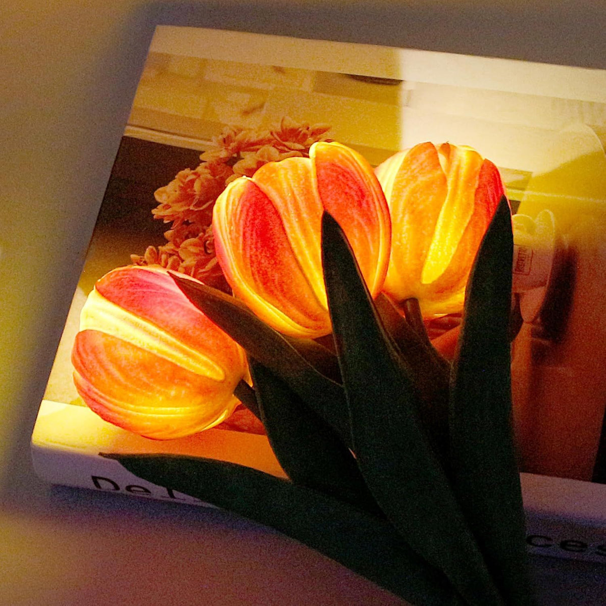 LED tulip table lamp with close-up glowing orange petals in a black-and-white base.