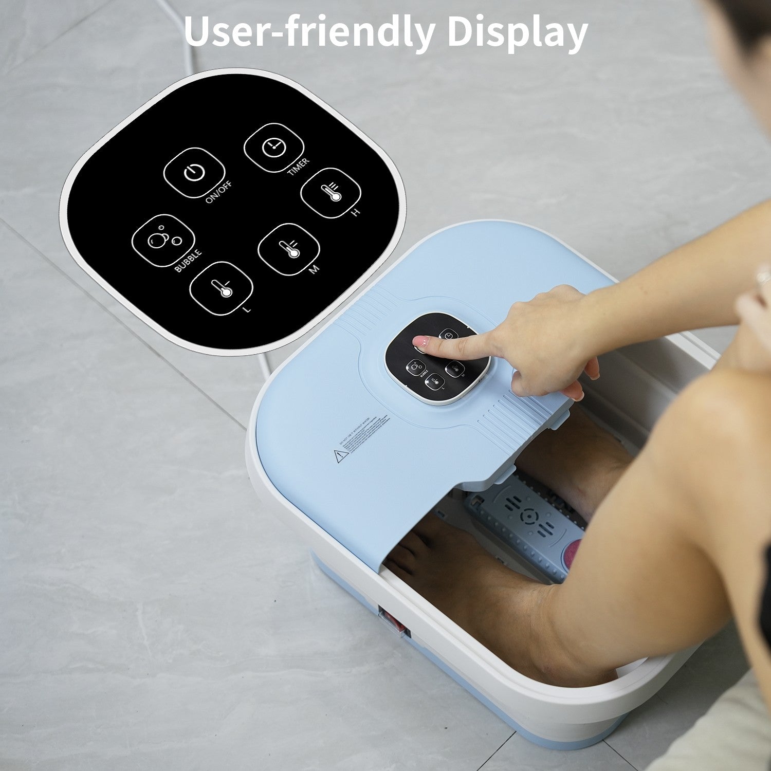 Electric foot spa with user control panel and remote display; hand presses buttons