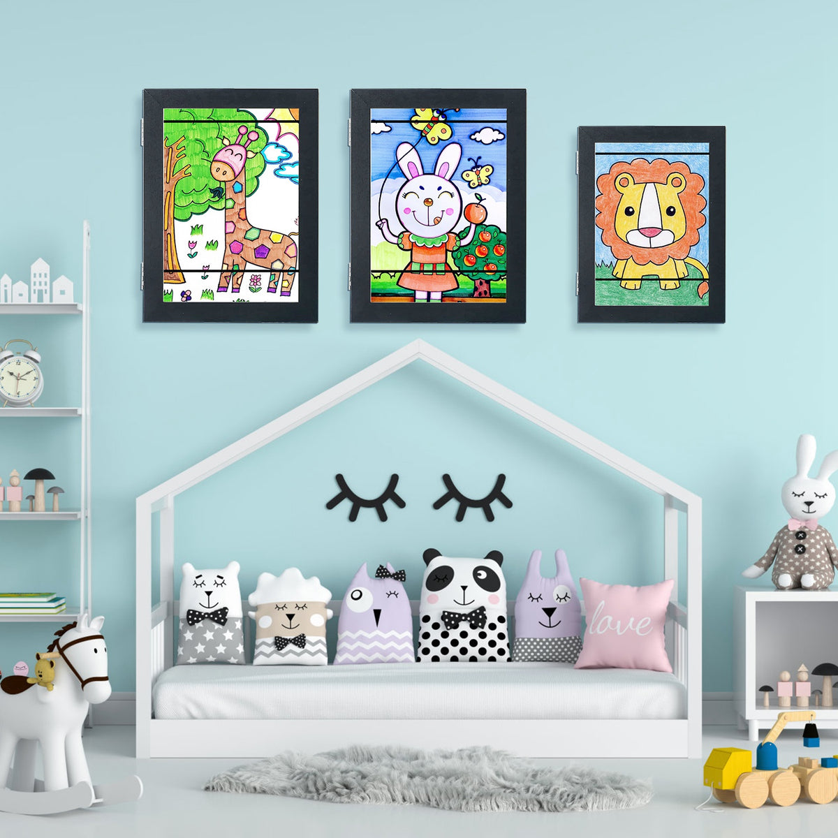 Kids A4 art frames set, front-opening black frames with glass, displayed on a wall.